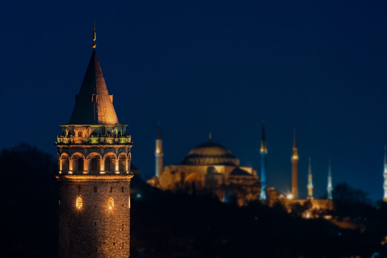 The Galata Tower at night, with Hagia Sophia and the Blue Mosque beyond